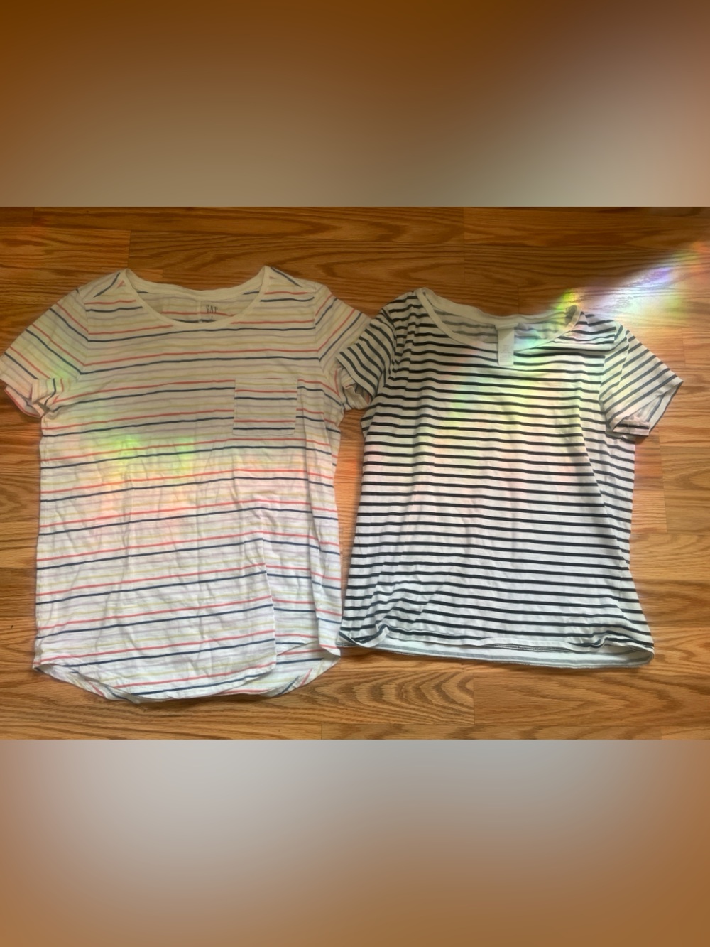 Two striped shirts, one colorful one black and white, Gap, H&M both size small